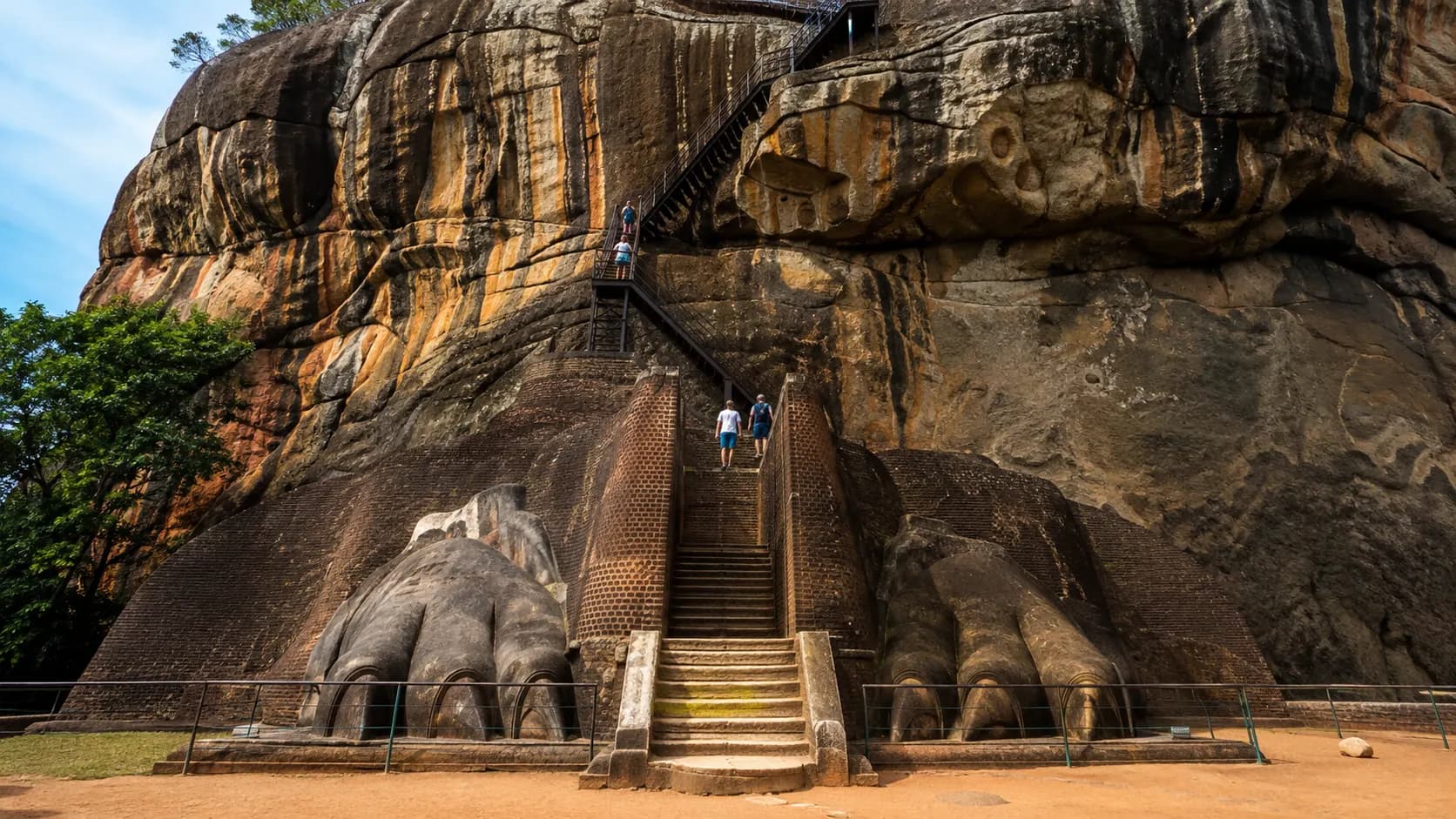 The surviving giant lion paws beside the staircase leading upward on Sigiriya Rock.
