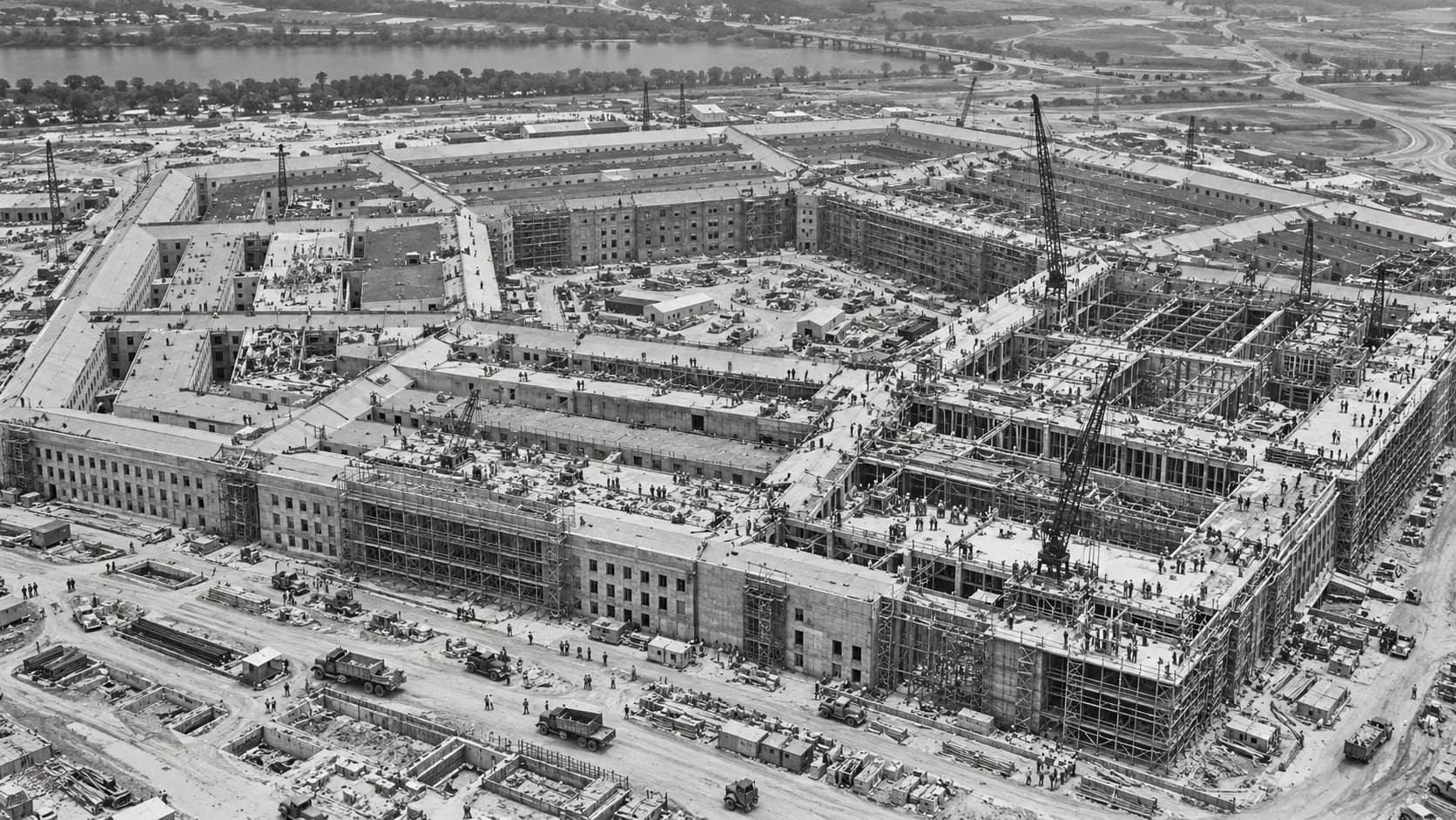 Construction workers and equipment surrounding the partially completed Pentagon during the early 1940s.